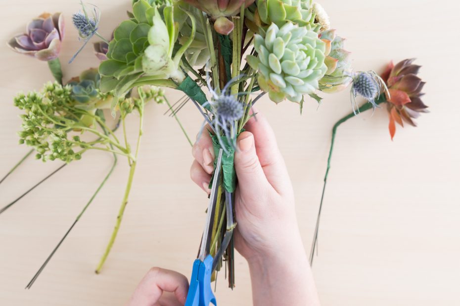 cut stems apart to disassemble succulent bridal bouquet for arrangement