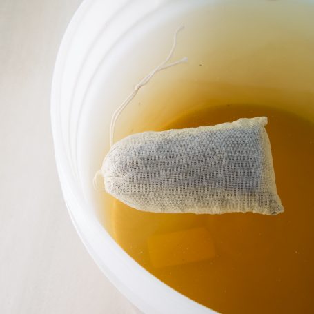 manure tea fertilizer bag in water after steeping