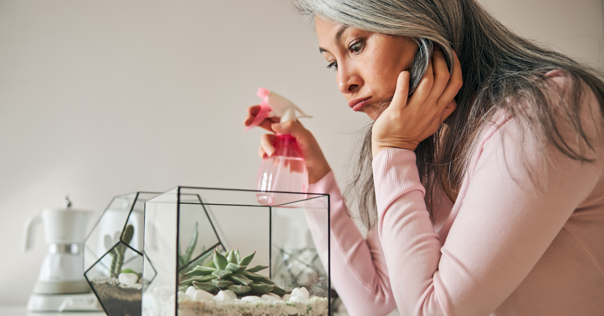 Adobe Stock Svitlana woman looking at terrarium frustrated