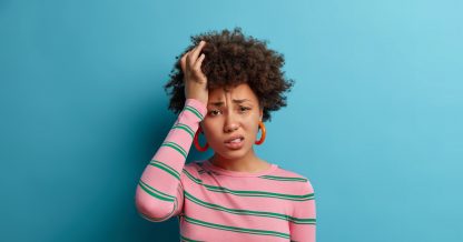 Adobe Stock Wayhome Studio frustrated disappointed woman pink shirt green stripes