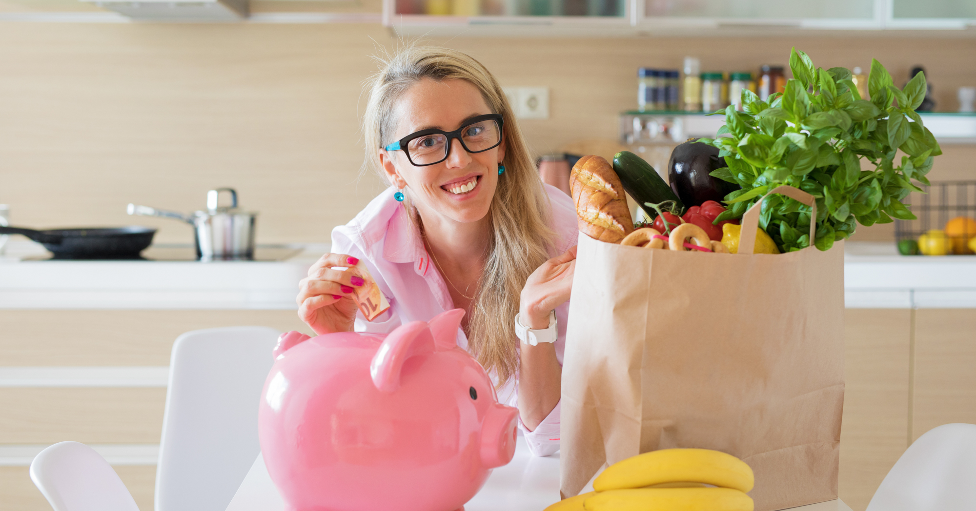 Adobe Stock Kaspars Grinvalds woman with glasses piggy bank groceries money house