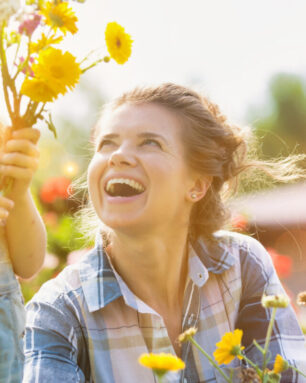 Mother and daughter picking pretty colourful flowers in their or