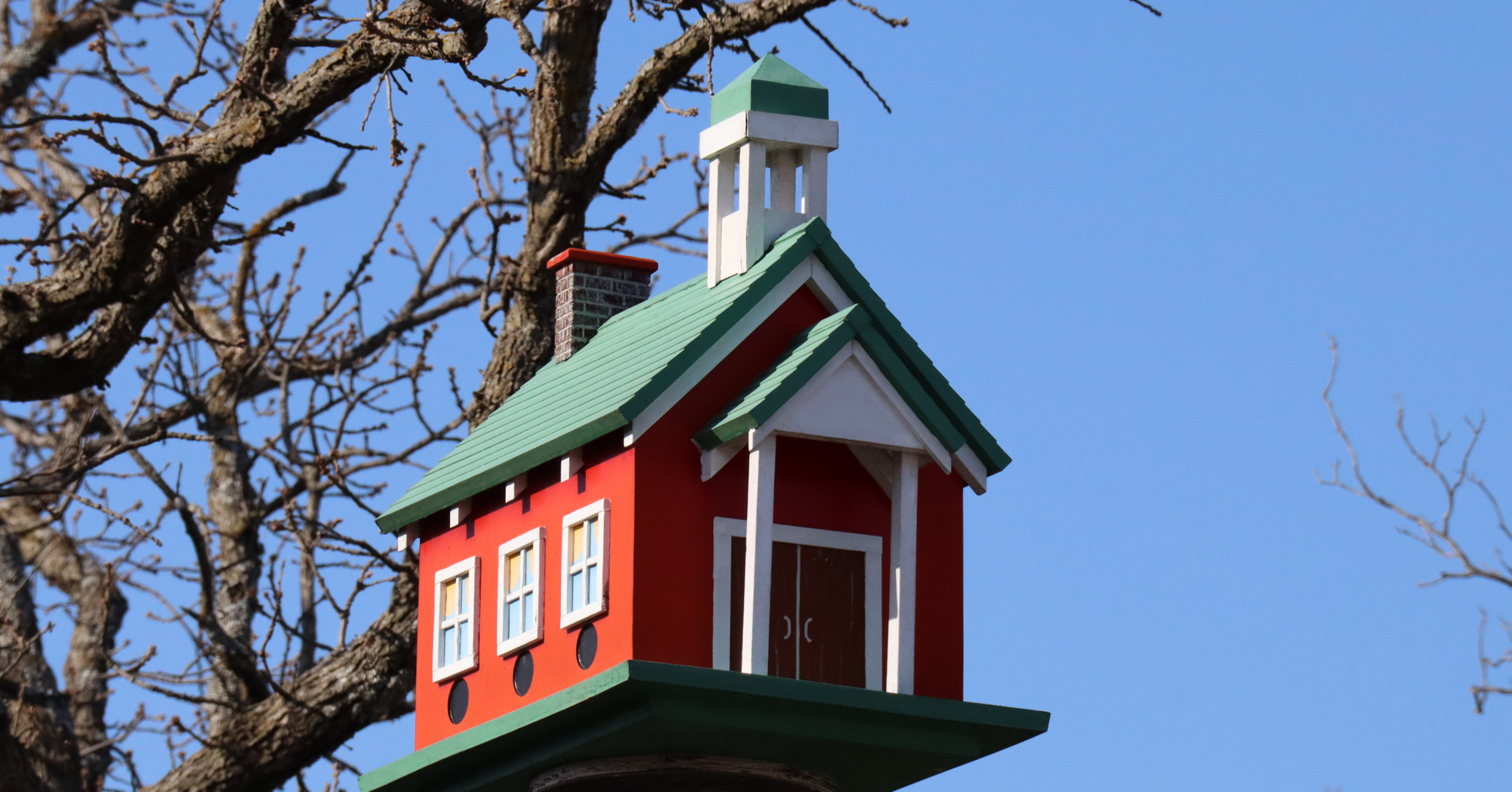 Adobe Stock Cynthia red green schoolhouse birdhouse freestanding outside