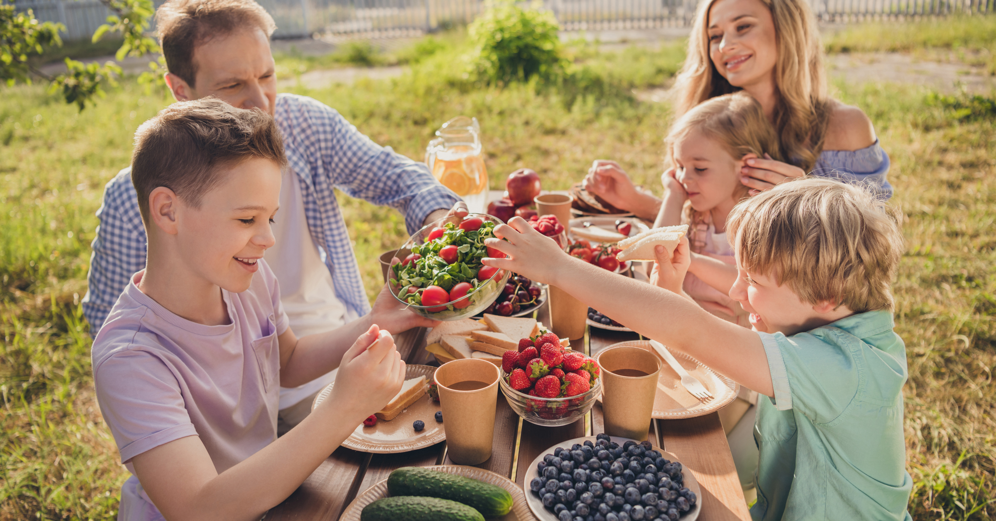 Adobe Stock Deagreez family harvest vegetables fresh fruit picnic eating outside table