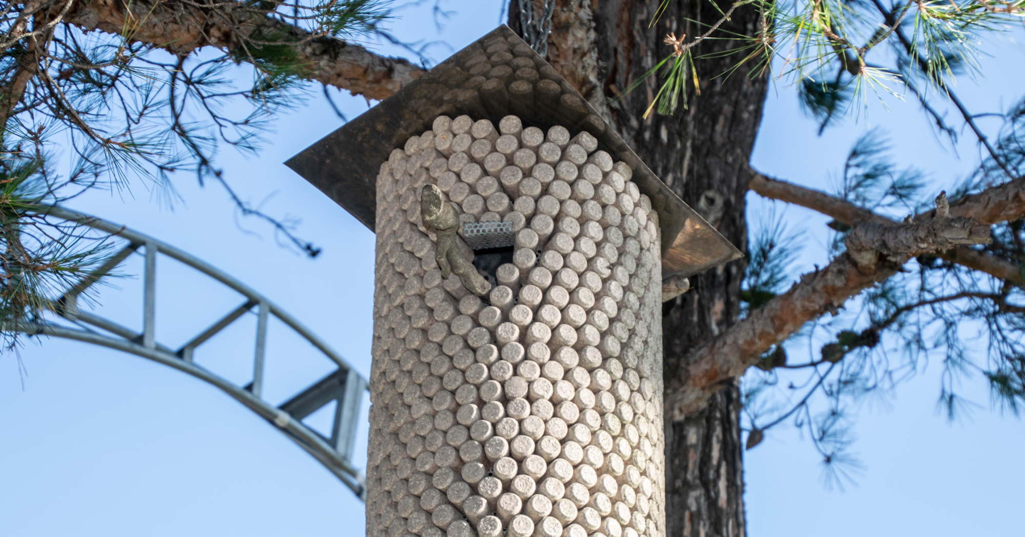 Adobe Stock Folga birdhouse made from wine bottle corks hanging in pine tree