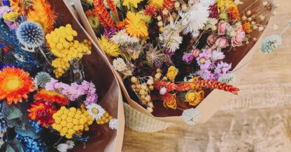 Adobe Stock Luoxi vibrant dried flower arrangement yellow red white purple blue wrapped wood